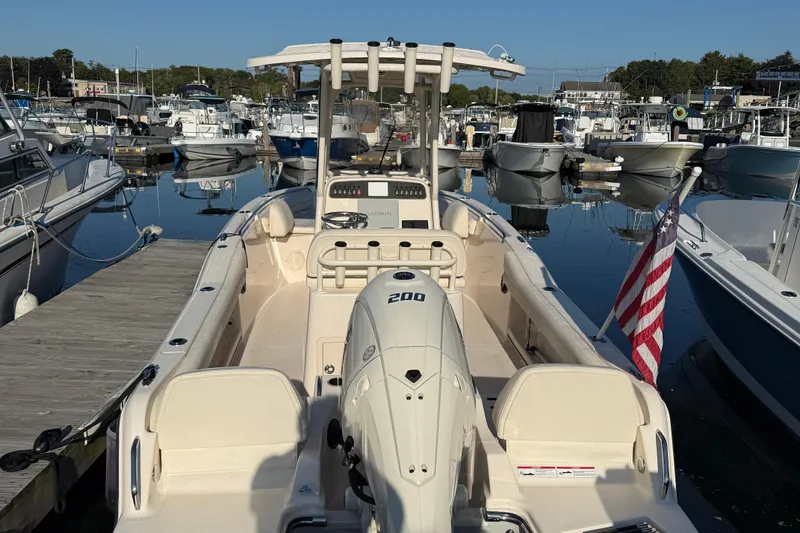 Slide: The Image of 2024 Grady-White Fisherman 216 boat with Yamaha engine and American flag at dock. - 3