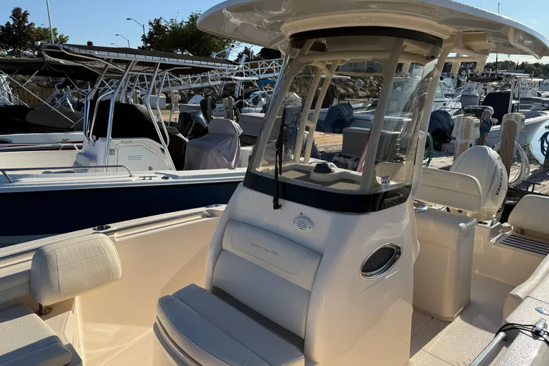Slide: The Image of 2024 Grady-White Fisherman 216 boat interior with steering wheel and seating. - 8