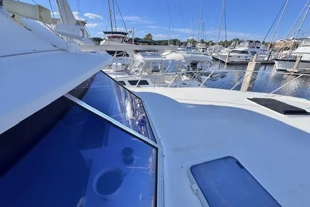 Slide: The Image of 1985 Silverton 40 ACMY yacht docked at marina under clear blue sky. - 11