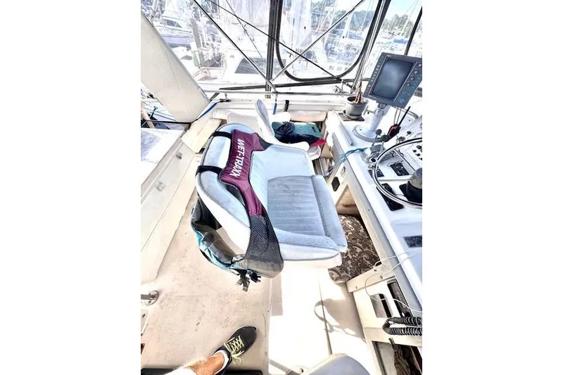 Slide: The Image of 1985 Silverton 40 ACMY yacht cockpit with seating and navigation equipment. - 21