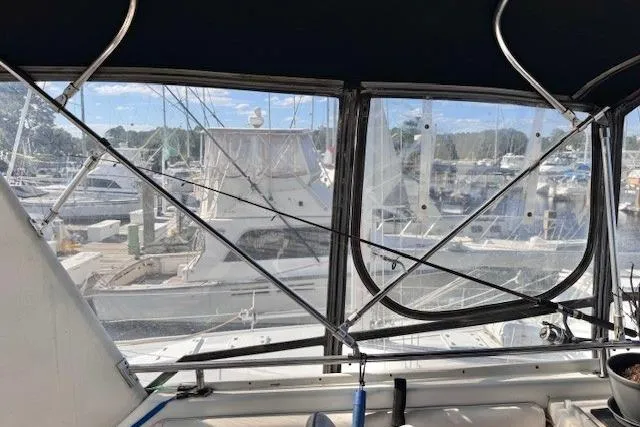 Slide: The Image of 1985 Silverton 40 ACMY yacht interior view with marina backdrop. - 25