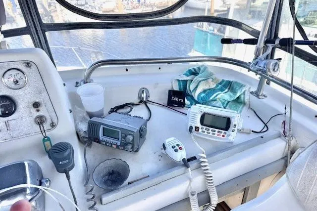 Slide: The Image of 1985 Silverton 40 ACMY boat cockpit with navigation equipment and marine radios. - 30
