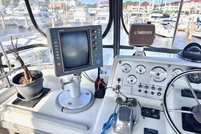 Slide: The Image of Cockpit of 1985 Silverton 40 ACMY with navigation equipment and bonsai plant. - 31