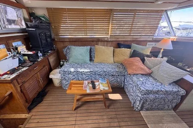 Slide: The Image of Interior of 1985 Silverton 40 ACMY yacht with cozy seating and wooden decor. - 34