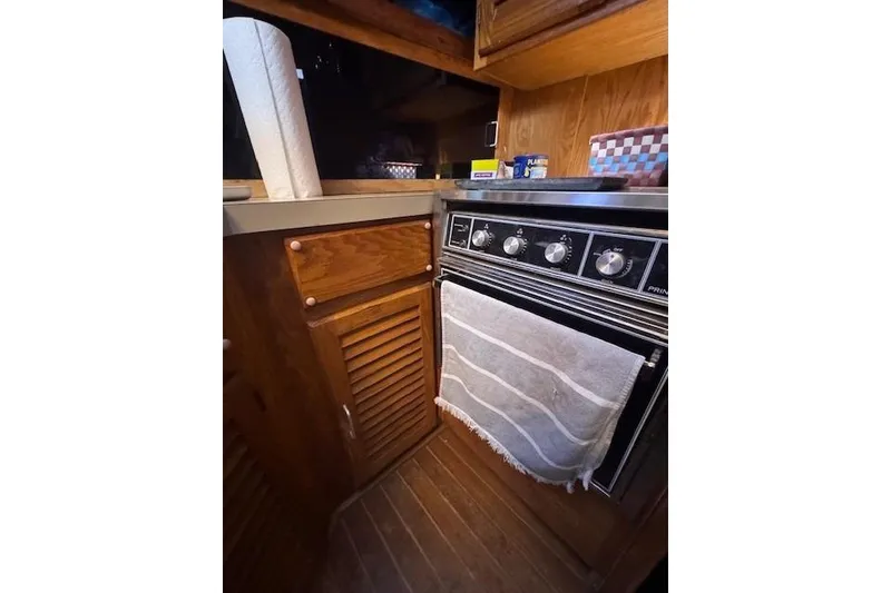 Slide: The Image of 1985 Silverton 40 ACMY kitchen with wooden cabinets and vintage stove. - 42