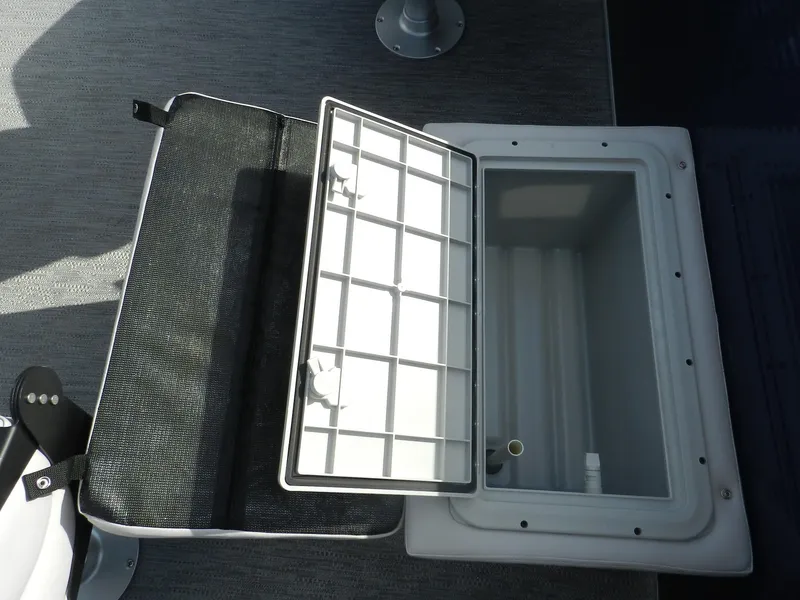 Slide: The Image of Open storage compartment on Sweetwater 2086FX boat, 2026 model, with grid cover. - 5