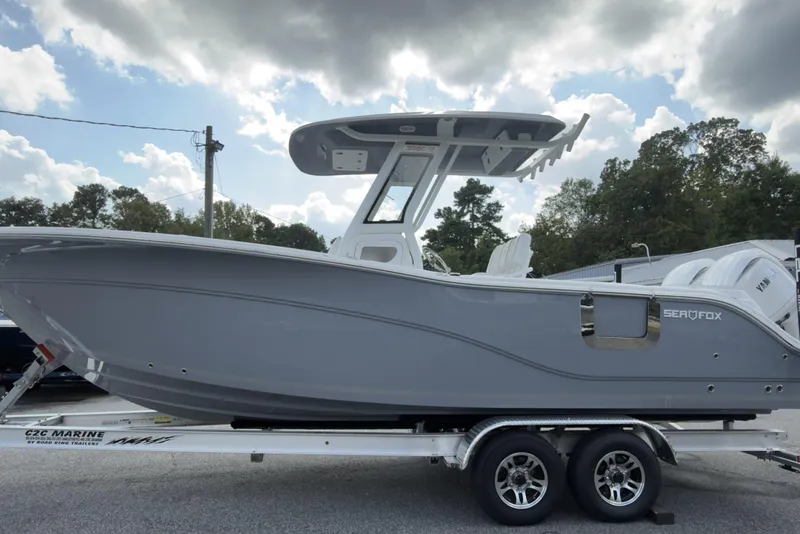 The Image of 2026 Sea Fox 268 Commander boat on trailer, under cloudy sky. - 0