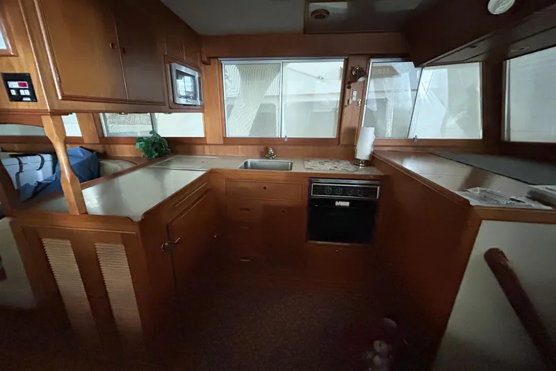 Slide: The Image of Interior of 1999 Grand Banks 46 Europa yacht kitchen with wooden cabinetry and appliances. - 15