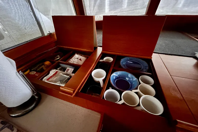 Slide: The Image of Interior of 1999 Grand Banks 46 Europa with organized kitchen storage and tableware. - 18