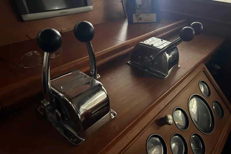 Slide: The Image of Control levers on a 1999 Grand Banks 46 Europa yacht dashboard. - 21