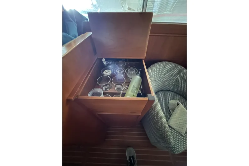 Slide: The Image of Open cabinet with glasses and bottle on 1999 Grand Banks 46 Europa yacht. - 26