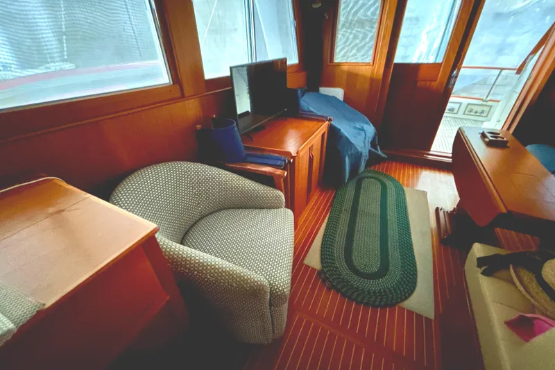 Slide: The Image of Interior of 1999 Grand Banks 46 Europa yacht with cozy seating and wooden decor. - 27