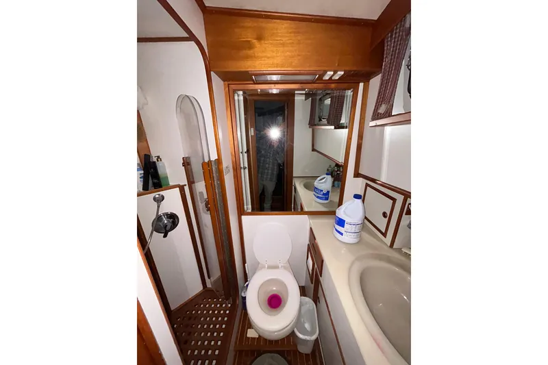 Slide: The Image of Bathroom interior of 1999 Grand Banks 46 Europa yacht, featuring toilet and sink. - 29