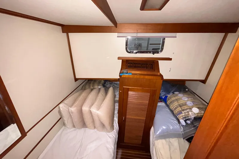Slide: The Image of Cabin interior of 1999 Grand Banks 46 Europa yacht with bedding and cushions. - 34