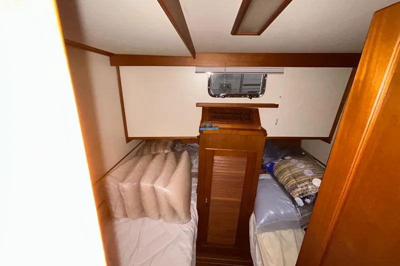 Slide: The Image of Cozy cabin interior of 1999 Grand Banks 46 Europa yacht with twin beds and wooden accents. - 35