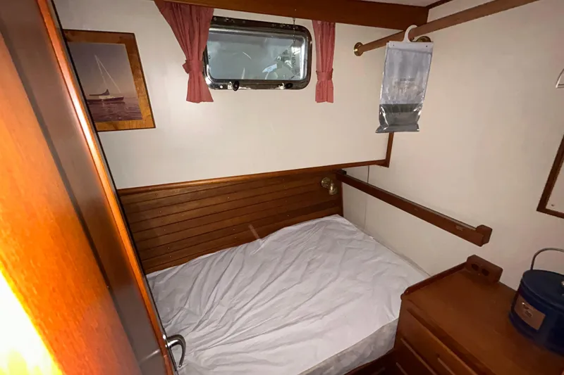 Slide: The Image of Cozy cabin interior of 1999 Grand Banks 46 Europa yacht with wooden accents and porthole. - 37
