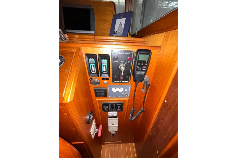 Slide: The Image of Control panel of a 1999 Grand Banks 46 Europa yacht with various instruments and switches. - 39