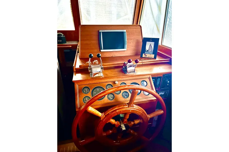 Slide: The Image of Helm of 1999 Grand Banks 46 Europa yacht with wooden wheel and navigation instruments. - 41