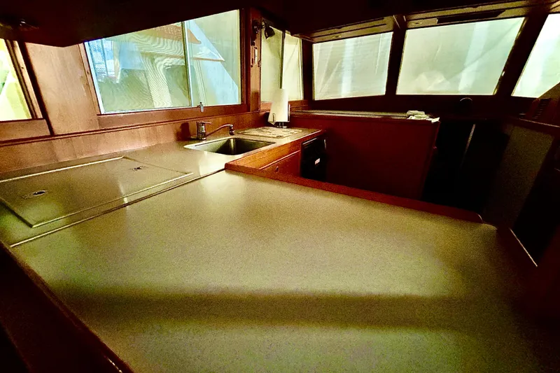 Slide: The Image of Interior of 1999 Grand Banks 46 Europa yacht, featuring a spacious kitchen area. - 42
