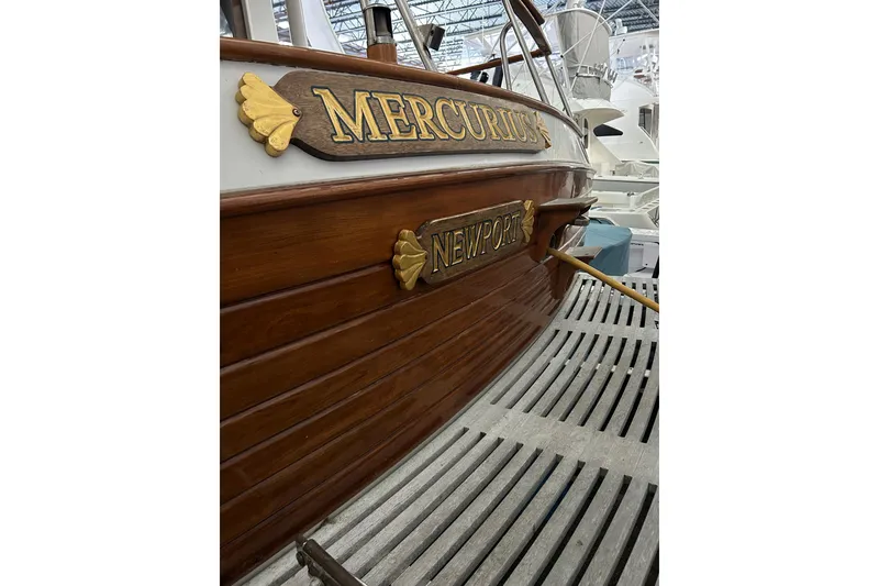 Slide: The Image of Wooden stern of 1999 Grand Banks 46 Europa boat with "Mercurius" and "Newport" signage. - 44