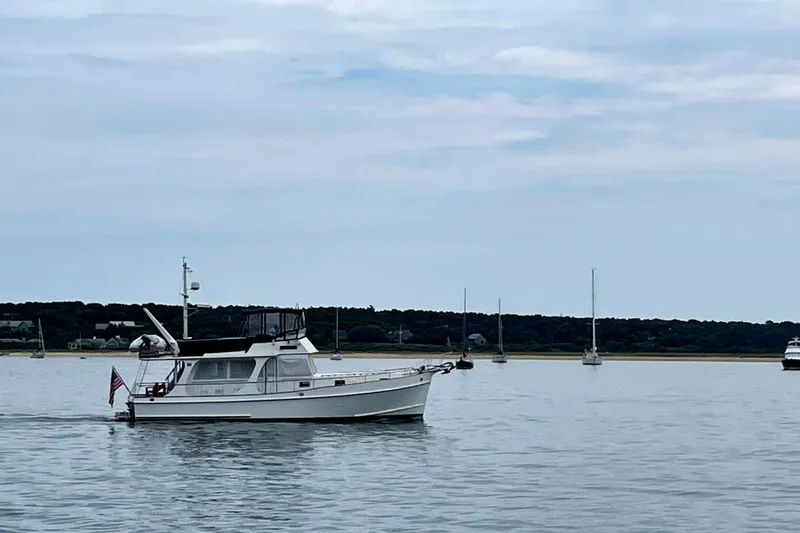 Slide: The Image of Grand Banks 46 Europa yacht from 1999 cruising on calm waters with sailboats in the background. - 53