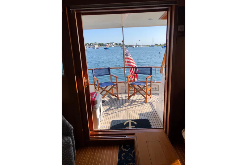 Slide: The Image of View from inside a 1999 Grand Banks 46 Europa yacht, overlooking a serene harbor. - 59