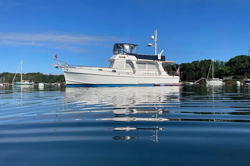 Slide: The Image of 1999 Grand Banks 46 Europa yacht on calm water, clear blue sky background. - 61