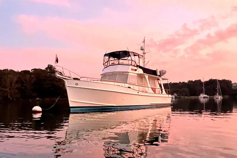 Slide: The Image of Grand Banks 46 Europa yacht on serene water at sunset, 1999 model. - 7