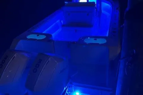 Slide: The Image of 2022 SeaHunter 31 Tournament boat with blue LED lighting at night. - 13