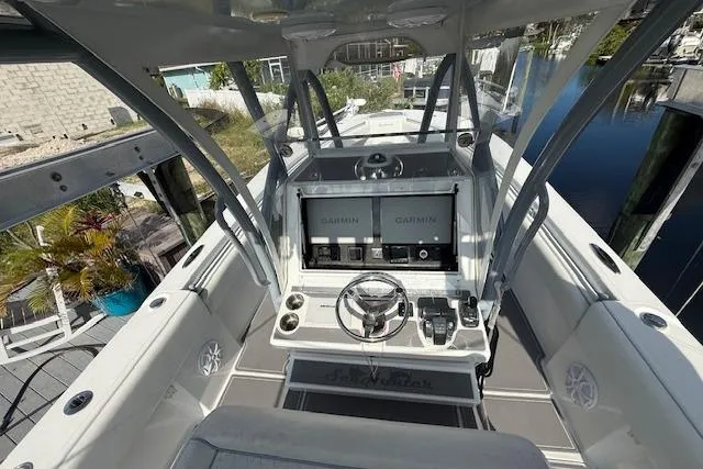 Slide: The Image of 2022 SeaHunter 31 Tournament boat cockpit with dual Garmin displays and steering wheel. - 7
