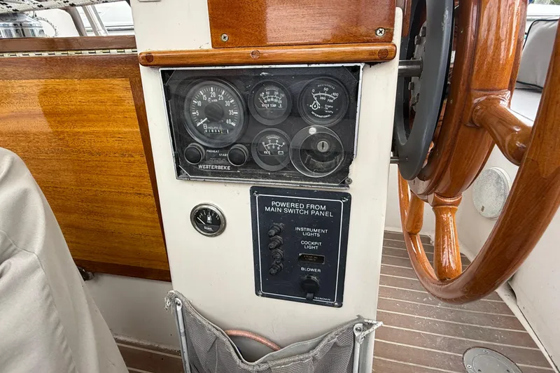 Slide: The Image of Control panel of a 1990 Gozzard 31 sailboat with wooden steering wheel. - 16