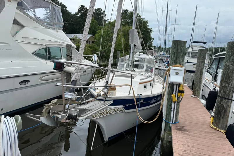 Slide: The Image of Sailboat Gozzard 31, 1990 model, docked at marina with surrounding yachts. - 21