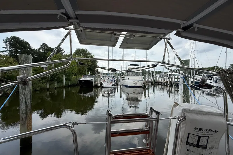 Slide: The Image of View from a 1990 Gozzard 31 sailboat docked at a marina, surrounded by other boats. - 4