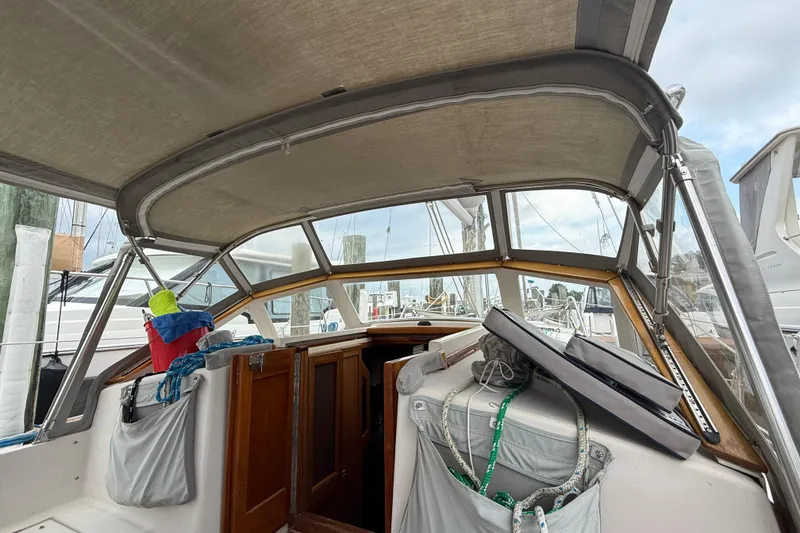 Slide: The Image of Cockpit view of a 1990 Gozzard 31 sailboat with covered seating and storage. - 5