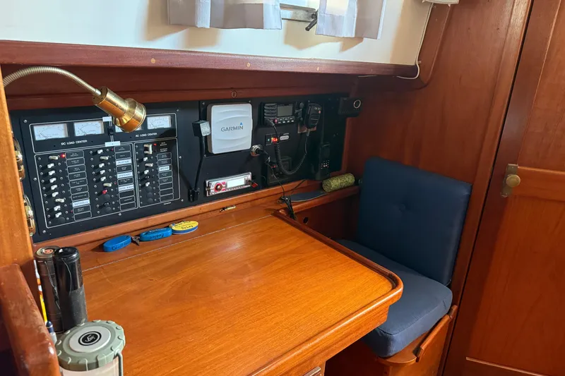 Slide: The Image of Navigation station of a 1990 Gozzard 31 sailboat with control panels and seating. - 8