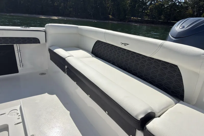 Slide: The Image of 2026 Tidewater 220 LXF boat interior with cushioned seating and sleek design. - 10