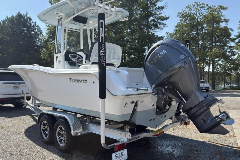 Slide: The Image of 2026 Tidewater 220 LXF boat on trailer with Yamaha outboard motor, parked outdoors. - 12