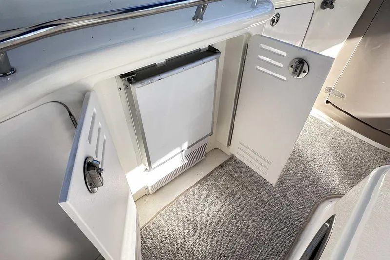 Slide: The Image of Open cabinet on 2000 Sea Ray 410 Sundancer yacht, revealing interior storage space. - 12