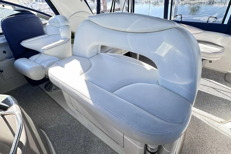 Slide: The Image of Interior seating of 2000 Sea Ray 410 Sundancer yacht, featuring plush white upholstery. - 13