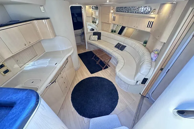 Slide: The Image of Luxurious interior of 2000 Sea Ray 410 Sundancer yacht with elegant seating and modern amenities. - 19