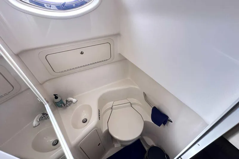 Slide: The Image of Bathroom interior of 2000 Sea Ray 410 Sundancer yacht, featuring sink and toilet. - 25