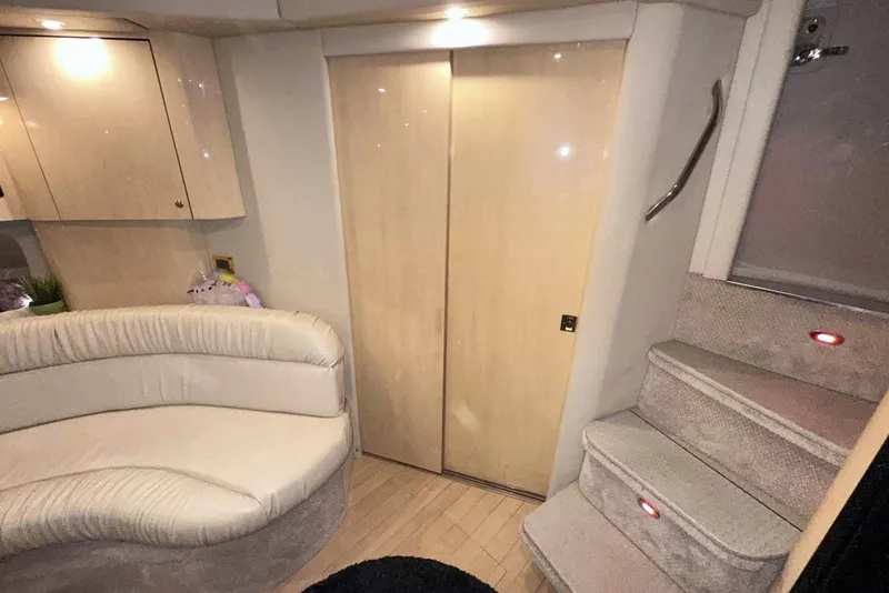Slide: The Image of Interior of 2000 Sea Ray 410 Sundancer with plush seating and carpeted stairs. - 27