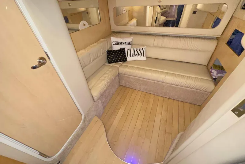 Slide: The Image of Interior of 2000 Sea Ray 410 Sundancer with beige seating and decorative pillows. - 28