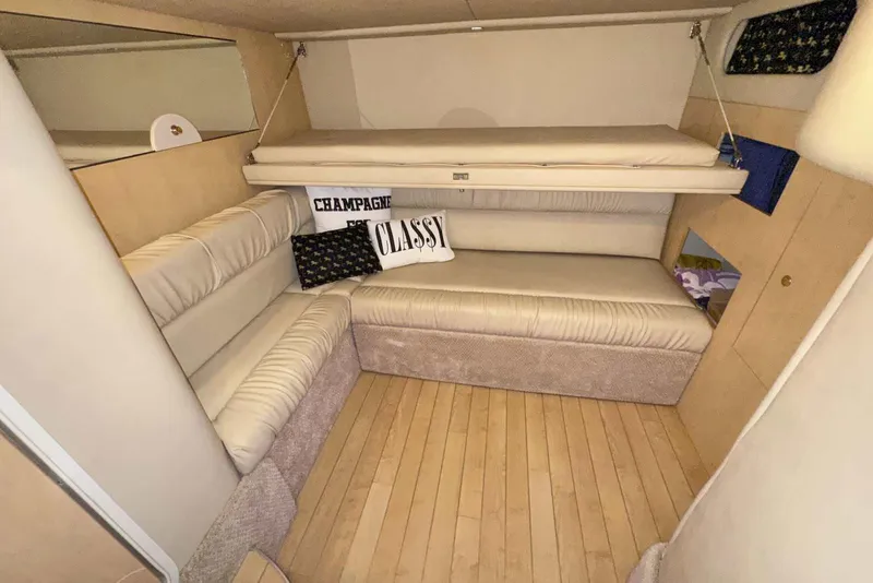 Slide: The Image of Interior of 2000 Sea Ray 410 Sundancer yacht with beige seating and decorative pillows. - 29