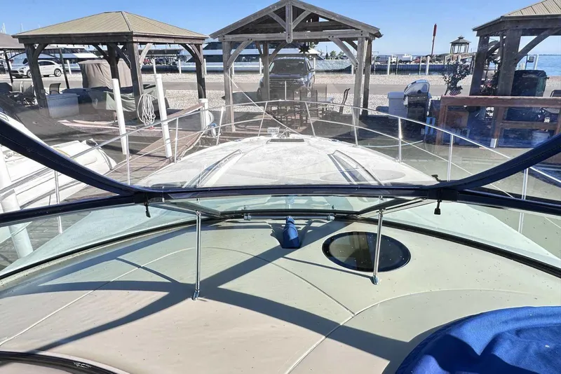 Slide: The Image of 2000 Sea Ray 410 Sundancer yacht docked at marina with clear blue sky. - 3