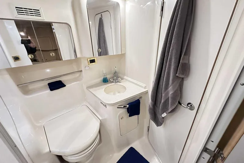 Slide: The Image of Bathroom interior of 2000 Sea Ray 410 Sundancer yacht, featuring sink and toilet. - 42