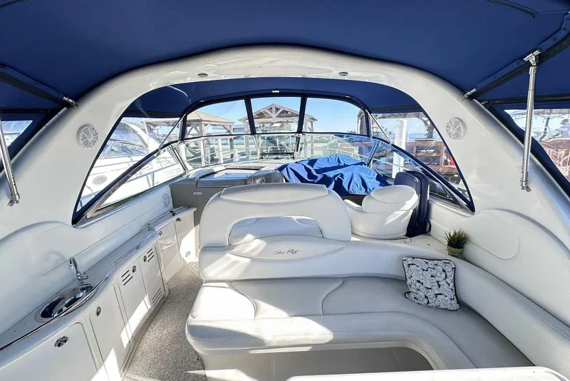 Slide: The Image of Interior of 2000 Sea Ray 410 Sundancer yacht with white seating and blue canopy. - 9