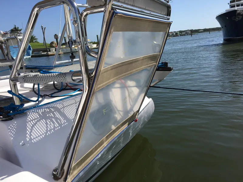 Slide: The Image of 2017 Corsair Cruze 970 #396 sailboat docked, featuring a mesh panel and stainless steel frame. - 13