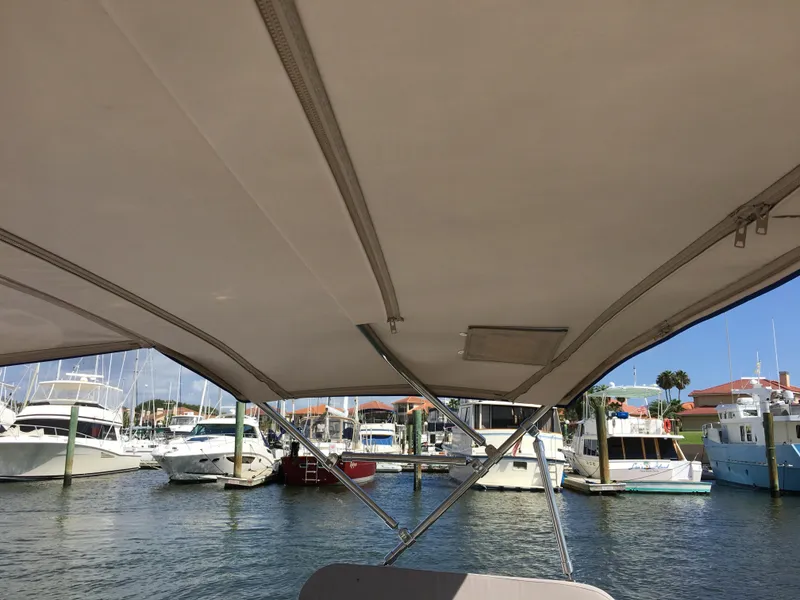Slide: The Image of View from a 2017 Corsair Cruze 970 #396 sailboat canopy in a marina. - 17