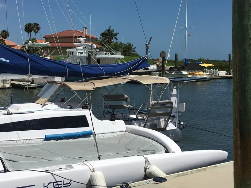 Slide: The Image of Sailboats docked at marina, featuring 2017 Corsair Cruze 970 #396. - 21